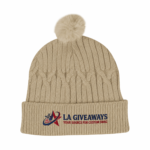 Sustainable cable knit beanie with a plush faux fur pom